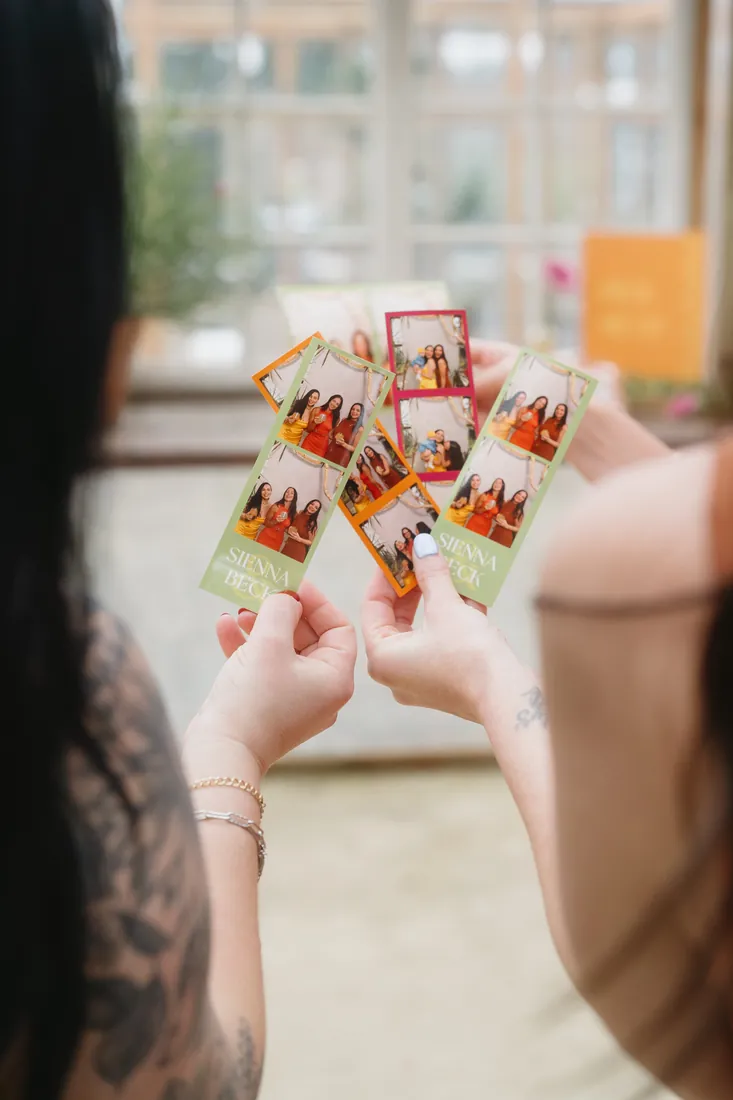 Guests holding fresh photo strips